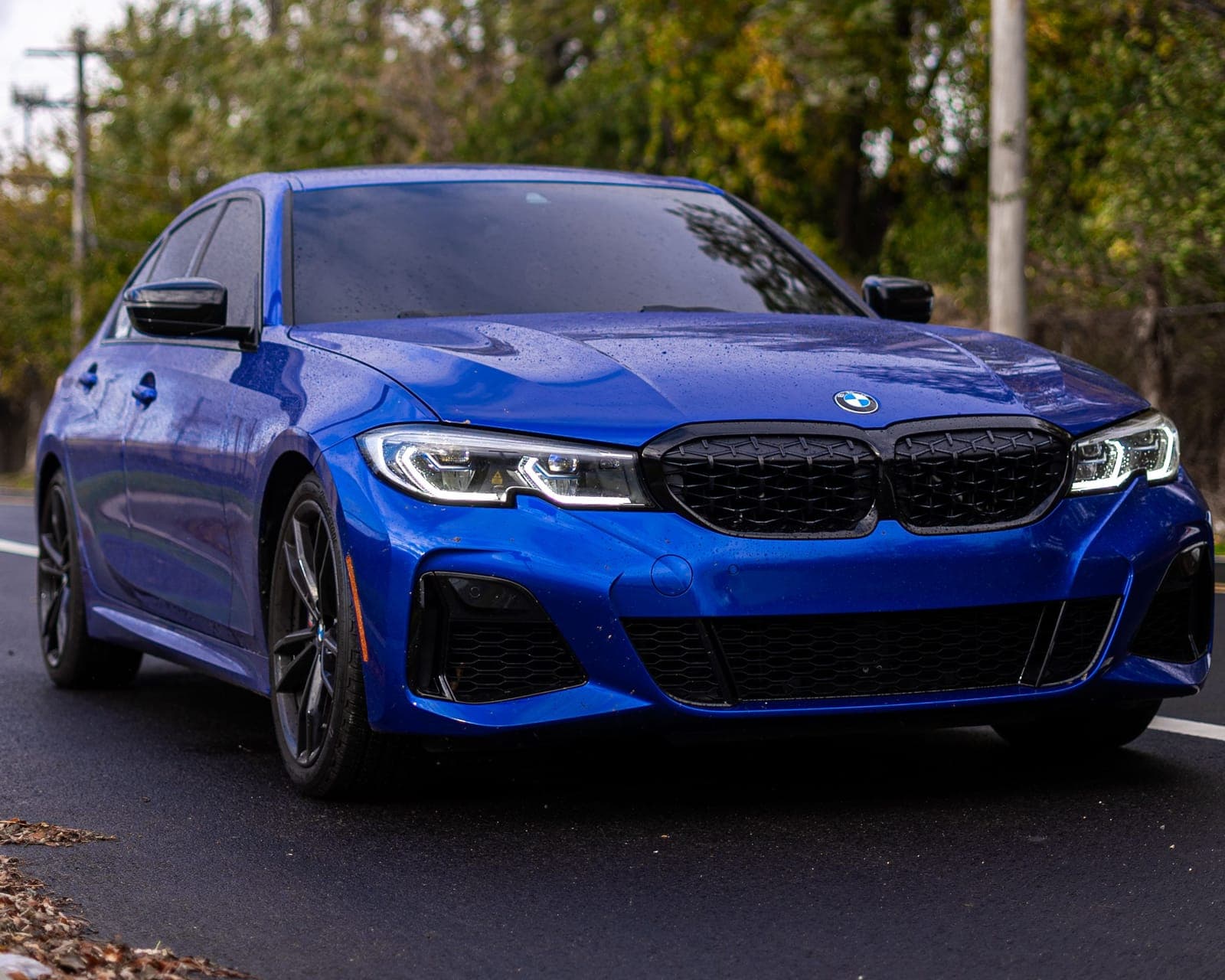A Portimao Blue BMW M340i being scanned for water spots, swirl marks, and brake dust